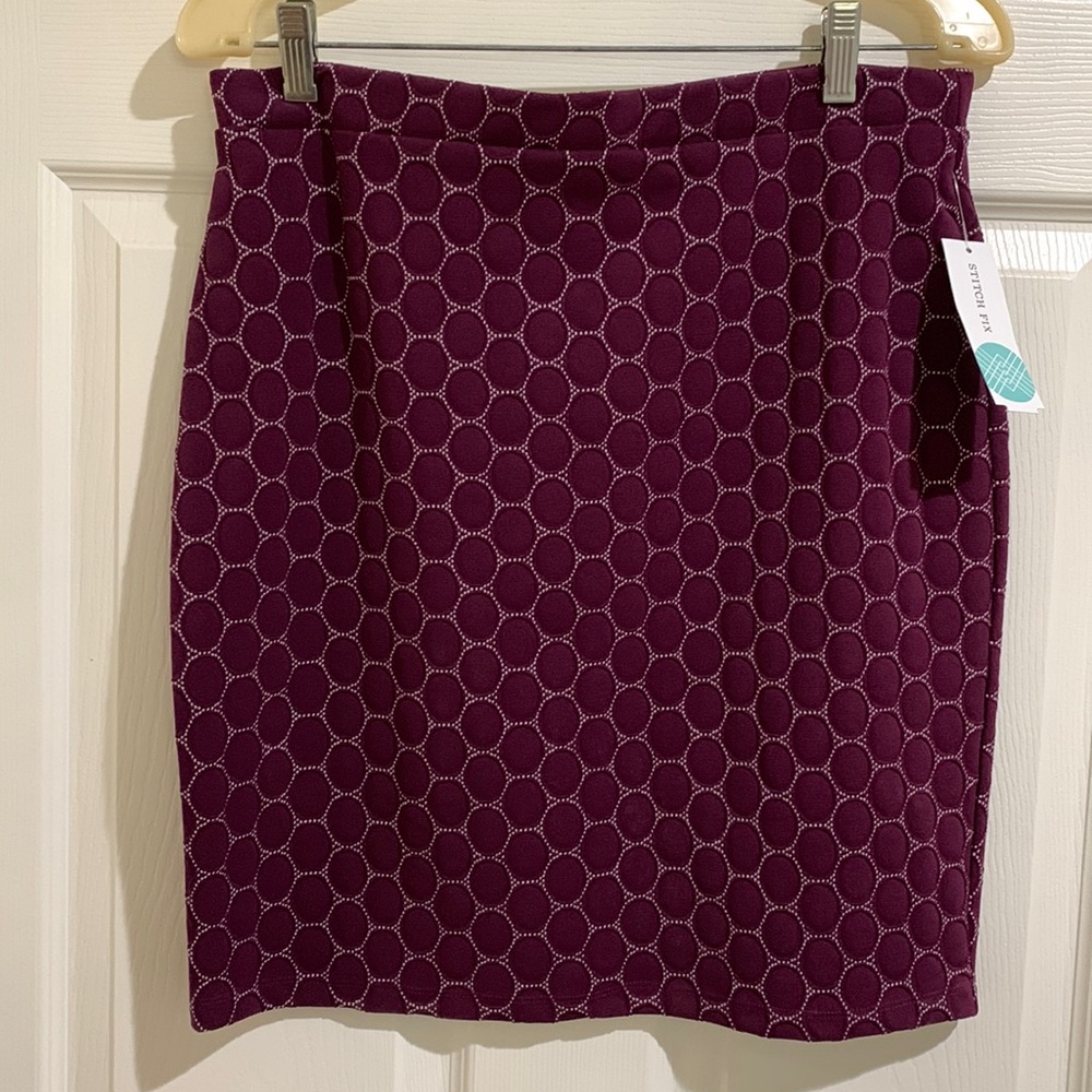 Modern design skirt. It is not a mini. Hits at my knee. Brand new never worn